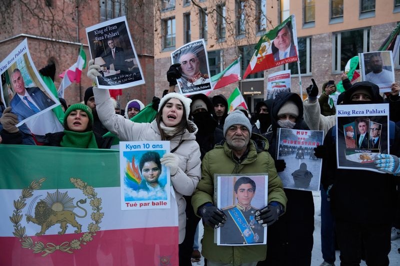 Protesters showing pictures of Reza Pahlavi at a demonstration in Berlin Germany in support of the nationwide mass protests in Iran