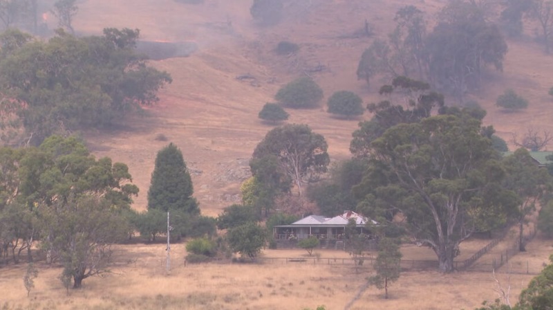 The fire could be seen burning slowly across dry grassland dangerously close to homesteads.